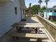 Spacious deck with outdoor table and benches for entertaining and relaxation at 1603 Lybrand St, Edisto Island, SC 29438