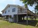 Charming elevated coastal home with a spacious deck, and outdoor recreational space at 1603 Lybrand St, Edisto Island, SC 29438