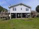Exterior of a raised beach house with a carport and stairs leading to the front door at 1603 Lybrand St, Edisto Island, SC 29438