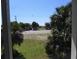Relaxing view of tropical palms and the clear sky from inside the home at 1603 Lybrand St, Edisto Island, SC 29438