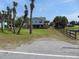 Coastal home with palm trees, a spacious yard, and classic beach charm at 1603 Lybrand St, Edisto Island, SC 29438