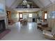 Open-concept living area with wood paneled walls, fireplace, and adjacent kitchen at 1603 Lybrand St, Edisto Island, SC 29438