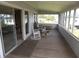Relaxing screened-in porch with seating at 1603 Lybrand St, Edisto Island, SC 29438