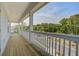 View of a balcony with white railings overlooking lush greenery and a street at 1619 Cultivation Ln, Mount Pleasant, SC 29466
