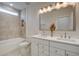 Elegant bathroom featuring dual sinks, modern lighting, and tiled shower-tub combination at 1619 Cultivation Ln, Mount Pleasant, SC 29466