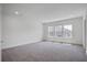Spacious bedroom featuring neutral carpeting and multiple windows at 1619 Cultivation Ln, Mount Pleasant, SC 29466