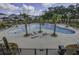 Aerial view of community pool with ample chairs and palm trees offering a resort-style experience at 1619 Cultivation Ln, Mount Pleasant, SC 29466