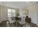 Formal dining room featuring modern decor, a large window, and hardwood floors at 1619 Cultivation Ln, Mount Pleasant, SC 29466