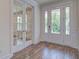 Bright entryway with hardwood floors, white trim, and double doors leading to the porch and another room at 1619 Cultivation Ln, Mount Pleasant, SC 29466
