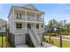 Stunning elevated two-story home featuring double porches, a two-car garage, and a beautifully landscaped yard at 1619 Cultivation Ln, Mount Pleasant, SC 29466