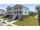 Beautiful elevated beach home featuring double porches, a spacious yard, and a two-car garage at 1619 Cultivation Ln, Mount Pleasant, SC 29466