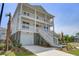 Elegant elevated home boasts double porches, a well-kept lawn, and classic coastal charm at 1619 Cultivation Ln, Mount Pleasant, SC 29466