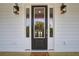 Inviting front door with sidelights and decorative lanterns, creating a welcoming entrance to the home at 1619 Cultivation Ln, Mount Pleasant, SC 29466
