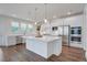 Stylish kitchen with a large island, white cabinets, and modern stainless steel appliances at 1619 Cultivation Ln, Mount Pleasant, SC 29466