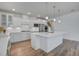 Bright kitchen boasts white cabinets, stainless appliances, and a large center island at 1619 Cultivation Ln, Mount Pleasant, SC 29466