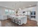 Stylish kitchen with a large island, white cabinets, and modern stainless steel appliances at 1619 Cultivation Ln, Mount Pleasant, SC 29466