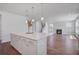 Open concept kitchen with a large island connects seamlessly to the living area with fireplace at 1619 Cultivation Ln, Mount Pleasant, SC 29466