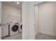 Well-equipped laundry room with modern washer and dryer, sink, and ample storage cabinets at 1619 Cultivation Ln, Mount Pleasant, SC 29466