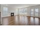 Bright, open living room featuring a fireplace, wood floors, and multiple windows at 1619 Cultivation Ln, Mount Pleasant, SC 29466