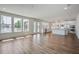 Open floor plan with living, dining, and kitchen areas; hardwood floors and natural light at 1619 Cultivation Ln, Mount Pleasant, SC 29466