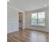 Bright living room with white trim, hardwood floors, and a large window at 1619 Cultivation Ln, Mount Pleasant, SC 29466