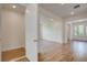 Open-concept living room with hardwood floors and white trim, leading to a foyer and dining room at 1619 Cultivation Ln, Mount Pleasant, SC 29466