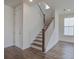 Bright staircase featuring stained wood treads and white risers and stringers at 1619 Cultivation Ln, Mount Pleasant, SC 29466