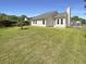 A view of the backyard and home, highlighting the grassy lawn and exterior at 1622 Pin Oak Cut, Mount Pleasant, SC 29466