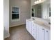 Bright bathroom featuring a double sink vanity, tiled floors, and a large window providing natural light at 1622 Pin Oak Cut, Mount Pleasant, SC 29466