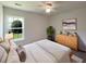 This bedroom offers ample natural light, a ceiling fan, and a decorative dresser at 1622 Pin Oak Cut, Mount Pleasant, SC 29466