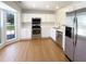 Modern kitchen boasting white cabinets, stainless steel appliances, and a window providing natural light at 1622 Pin Oak Cut, Mount Pleasant, SC 29466