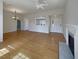 Open-concept living area with a fireplace, hardwood floors, a ceiling fan, and easy access to the front entrance at 1622 Pin Oak Cut, Mount Pleasant, SC 29466
