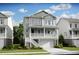 Charming two-story home featuring a garage and inviting front porch with white railing and a well-manicured lawn at 1664 Siloh St # 471, Mount Pleasant, SC 29466