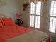 Bright bedroom with a orange-toned bed, floral window treatments, and natural light at 1757 Wayah Dr, Charleston, SC 29414