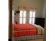 Comfortable bedroom with an orange-toned bed, floral window treatments, and natural light at 1757 Wayah Dr, Charleston, SC 29414