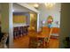 Bright dining room with hardwood floors, wooden table, chandelier, and breakfast bar overlooking the kitchen at 1757 Wayah Dr, Charleston, SC 29414