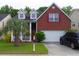 Charming two-story brick home with a well-manicured lawn and a palm tree in the front yard at 1757 Wayah Dr, Charleston, SC 29414