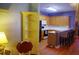 Open kitchen featuring wooden cabinets, breakfast bar, and hardwood floors with a yellow corner shelf nearby at 1757 Wayah Dr, Charleston, SC 29414