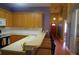 Kitchen with wooden cabinets, breakfast bar with seating, and hardwood floors leading to a hallway at 1757 Wayah Dr, Charleston, SC 29414