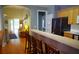 Kitchen with breakfast bar leading to a living area with sliding doors to the deck at 1757 Wayah Dr, Charleston, SC 29414