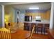 Dining area with wooden table, breakfast bar, and stainless steel appliances in an open-concept layout at 1757 Wayah Dr, Charleston, SC 29414