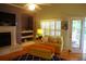 Comfortable living room with a fireplace, built-in shelves, hardwood floors, and access to an outdoor deck at 1757 Wayah Dr, Charleston, SC 29414