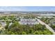Aerial shot of apartments surrounded by trees and a pond with distant marshlands and road access at 1984 Folly Rd # A307, Charleston, SC 29412