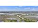 Expansive aerial view capturing marshland, coastal highway, and distant ocean horizon under a partly cloudy sky at 1984 Folly Rd # A307, Charleston, SC 29412