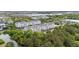 An aerial view of modern apartments, surrounding trees, and a nearby pond in a serene neighborhood at 1984 Folly Rd # A307, Charleston, SC 29412