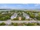 A drone image shows modern apartments with pool, landscaping, and nearby highway access amidst lush greenery at 1984 Folly Rd # A307, Charleston, SC 29412