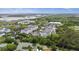 An aerial view of modern condos with a pool, mature trees, and nearby marsh and commercial establishments at 1984 Folly Rd # A307, Charleston, SC 29412
