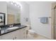 Bright bathroom featuring a granite countertop, white cabinets, and tile shower with glass door at 1984 Folly Rd # A307, Charleston, SC 29412