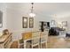 Dining room with a wooden table with seating for six highlighted by a decorative light fixture at 1984 Folly Rd # A307, Charleston, SC 29412