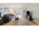 Comfortable living room with hardwood floors, a ceiling fan, and a view into the sunroom at 1984 Folly Rd # A307, Charleston, SC 29412